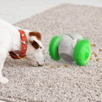 Dog using an interactive treat dispensing puzzle toy